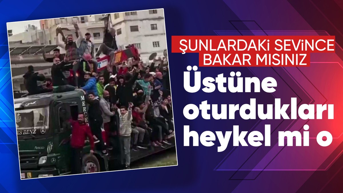 Suriyelilerin yıkılan Esad heykeli üzerindeki eğlencesi kameraya yansıdı